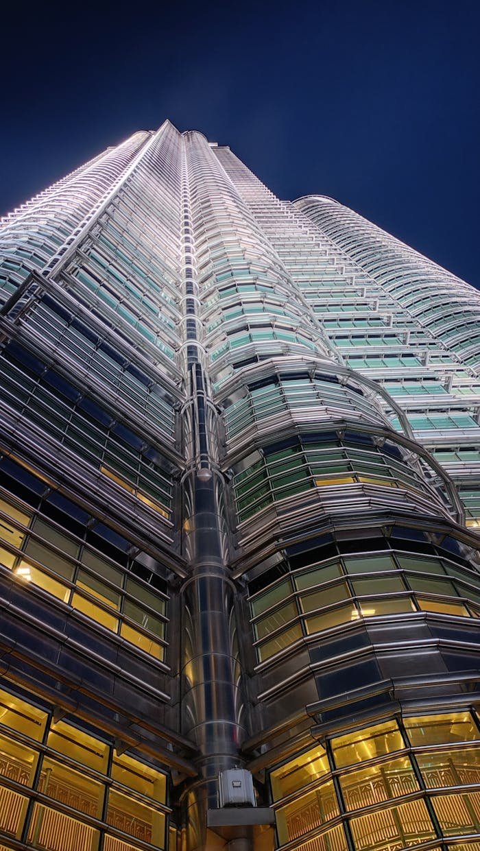who-we-are A stunning night view of the Petronas Towers in Kuala Lumpur, showcasing modern architecture.