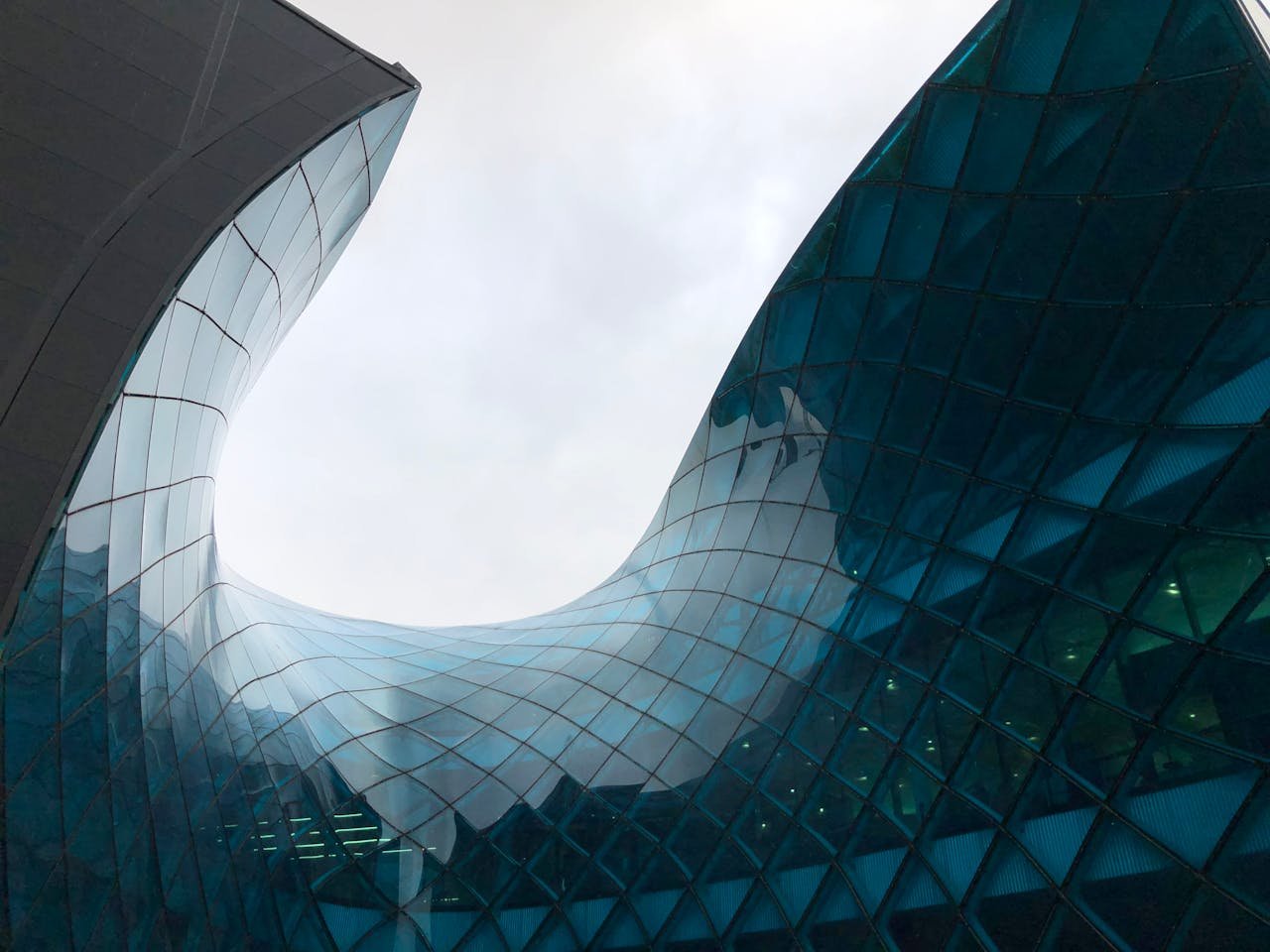 services-03 Dynamic view of curved glass architecture captures modern and innovative design.